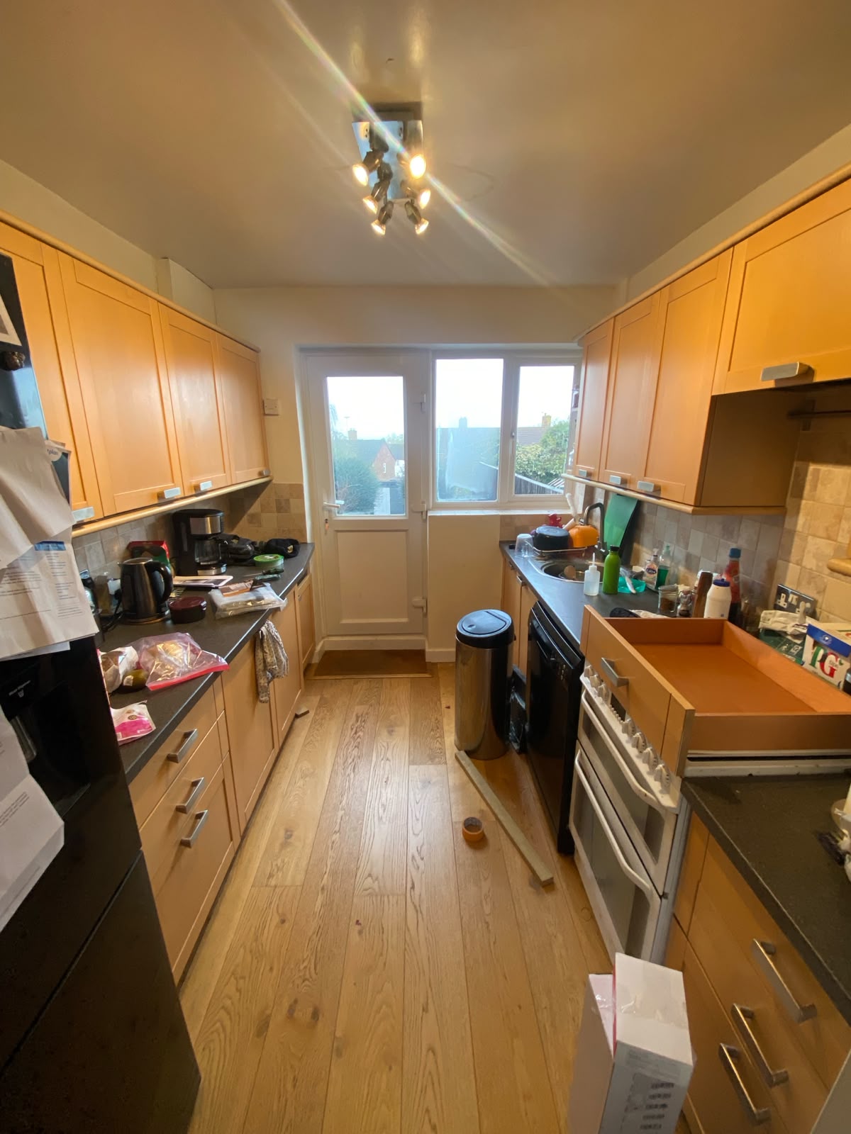 Tired, dated galley kitchen. 